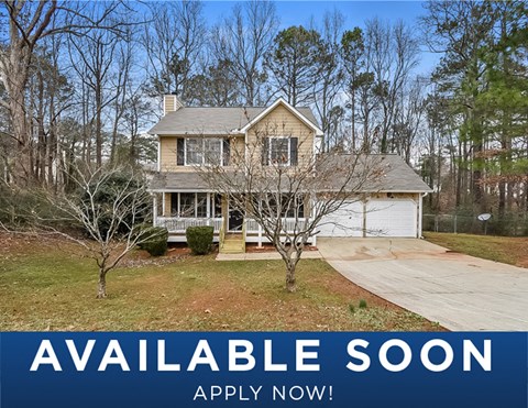 a home with a yard and trees and a sign that reads